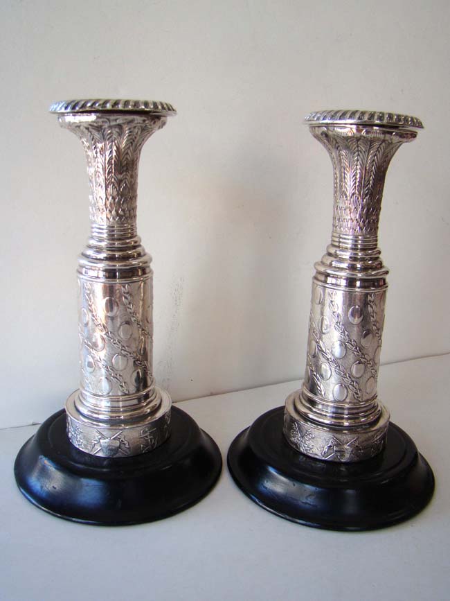 A rare pair of English silver plated candlesticks circa 1798-1800 commemorating English naval victories.